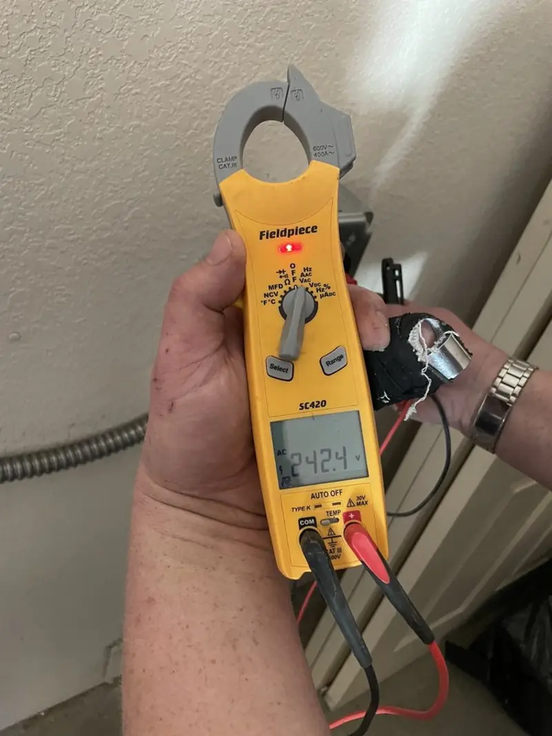 Voltage testing with clamp meter during Ceiling Fan Installation in Slinger